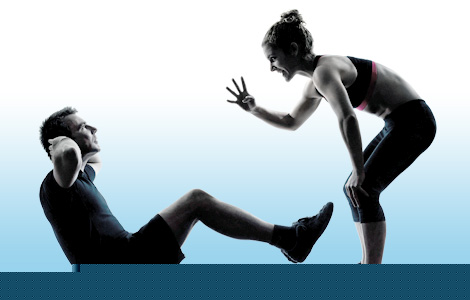 A personal trainer with a client performing an exercise